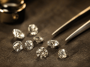 Loose brilliant-cut diamonds arranged on a neutral surface