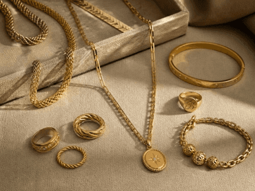Fine gold and gemstone jewelry displayed on linen