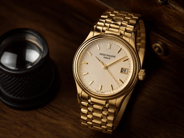 Luxury steel wristwatch on a neutral surface
